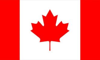 The Canadian flag. The left is Red, white middle is white with a red maple leaf, and the right side is red. Canndelta is a cannabis licensing firm that helps cannabis business in Canada.