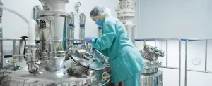 pharmaceutical worker operating a production line on a page about EU GMP Certification for Cannabis