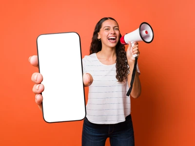 A girl holding a microphone and a phone