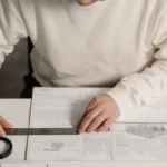 Regulatory compliance consultant conducting a blueprint and floor plan review for a commercial cannabis facility.